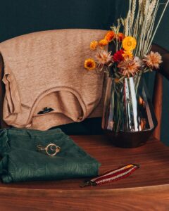 folded shirt and jeans on wooden chair